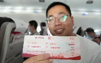Passenger shows ticket aboard the first commercial flight of a Chinese Comac C-919 aircraft operated with passengers on May 28, 2023 by China Eastern Airlines